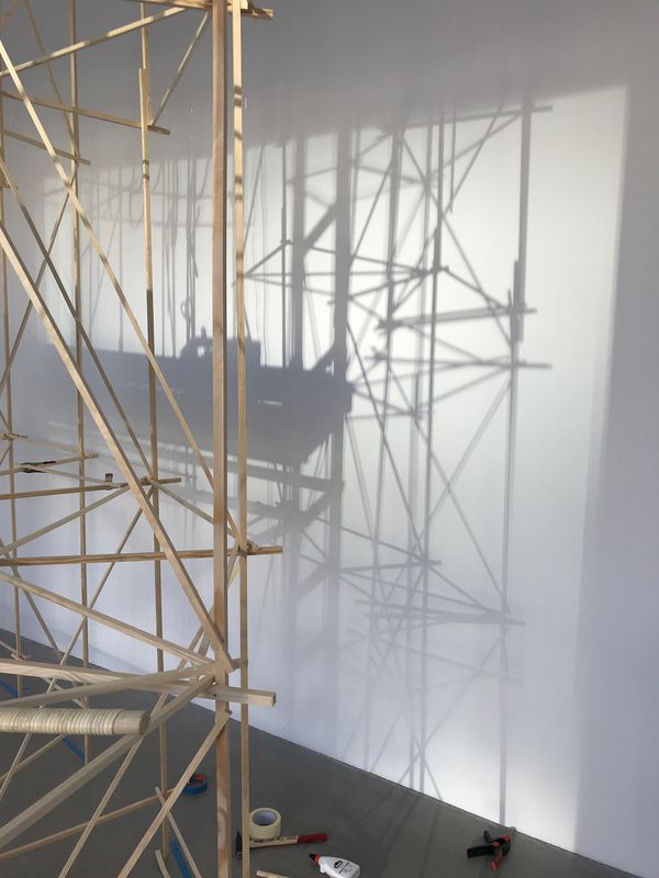 A woven flat reed installation titled Hive: Berlin by Stephen Talasnik, photographed while under construction at Architektur Galerie, Berlin.