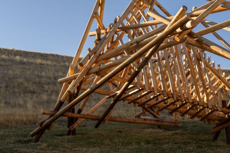 A large wooden installation titled Pioneer by Stephen Talasnik.