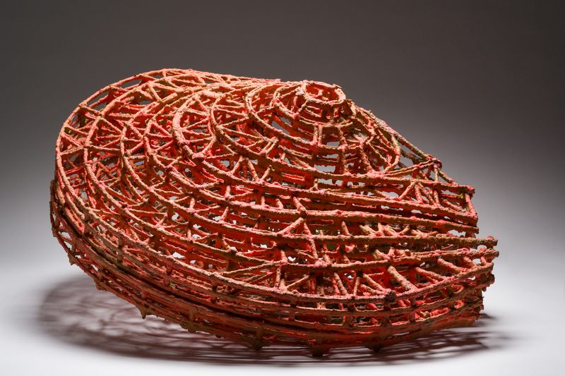 A painted basswood with metallic pigment sculpture titled Leaning Globe by Stephen Talasnik.