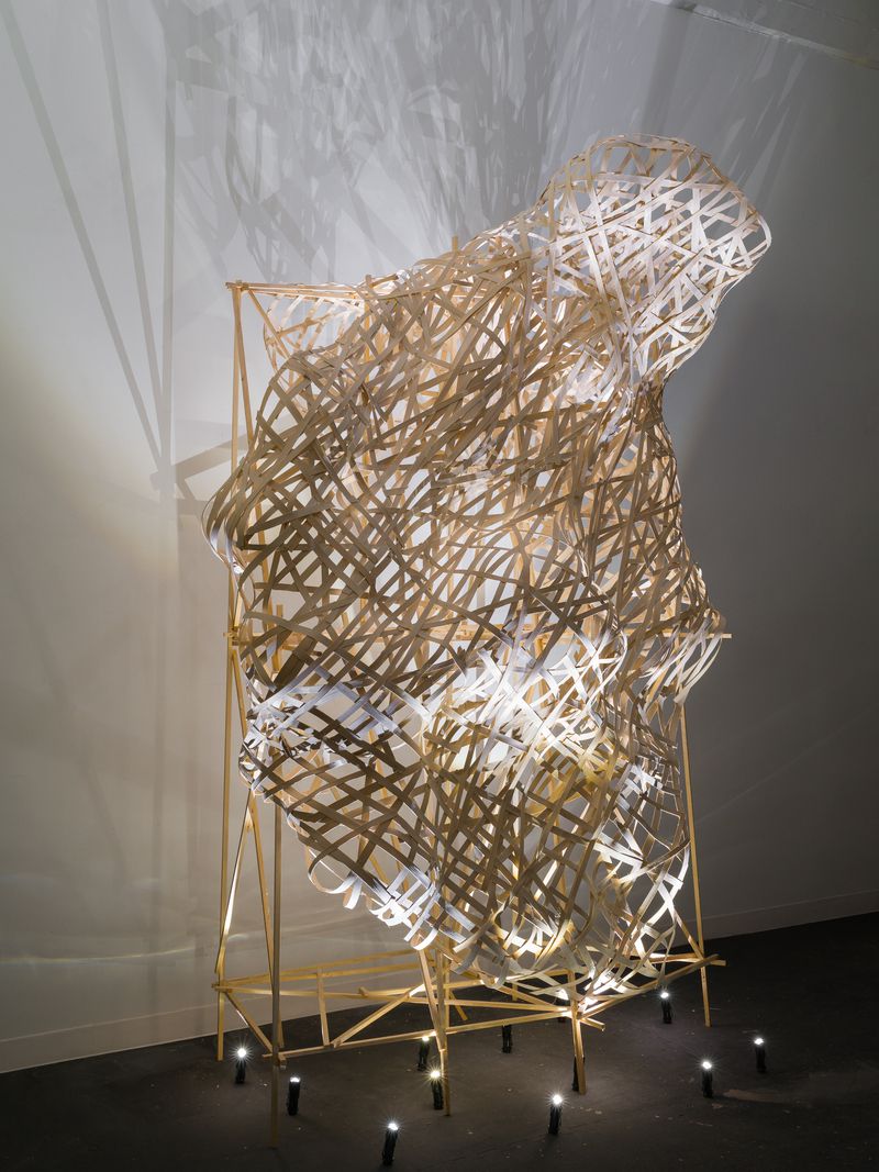 A woven flat reed and pine infrastructure sculpture titled Screen by Stephen Talasnik.