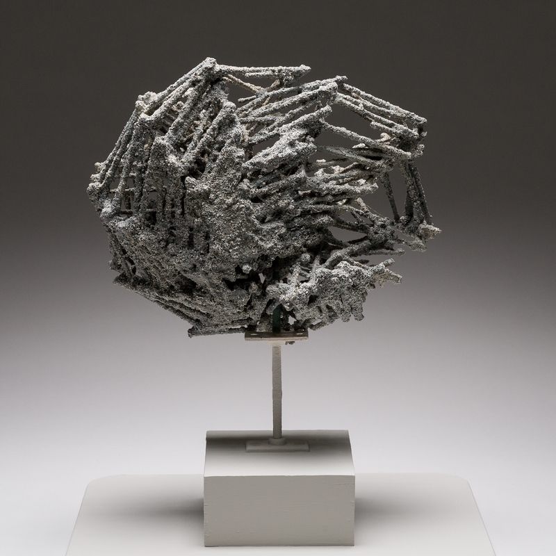 A quarry stone, pigment, acrylic resin, and wood sculpture titled Debris Field #27: Twister by Stephen Talasnik.