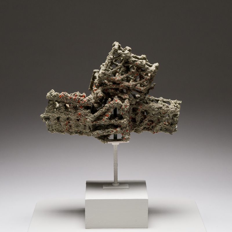 A quarry stone, pigment, acrylic resin, and wood sculpture titled Debris Field #74: Impact by Stephen Talasnik.